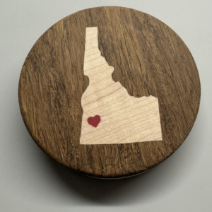 Hockey puck bottle opener with maple Idaho inlay and red epoxy heart over the Treasure Valley — handmade by Langskegg